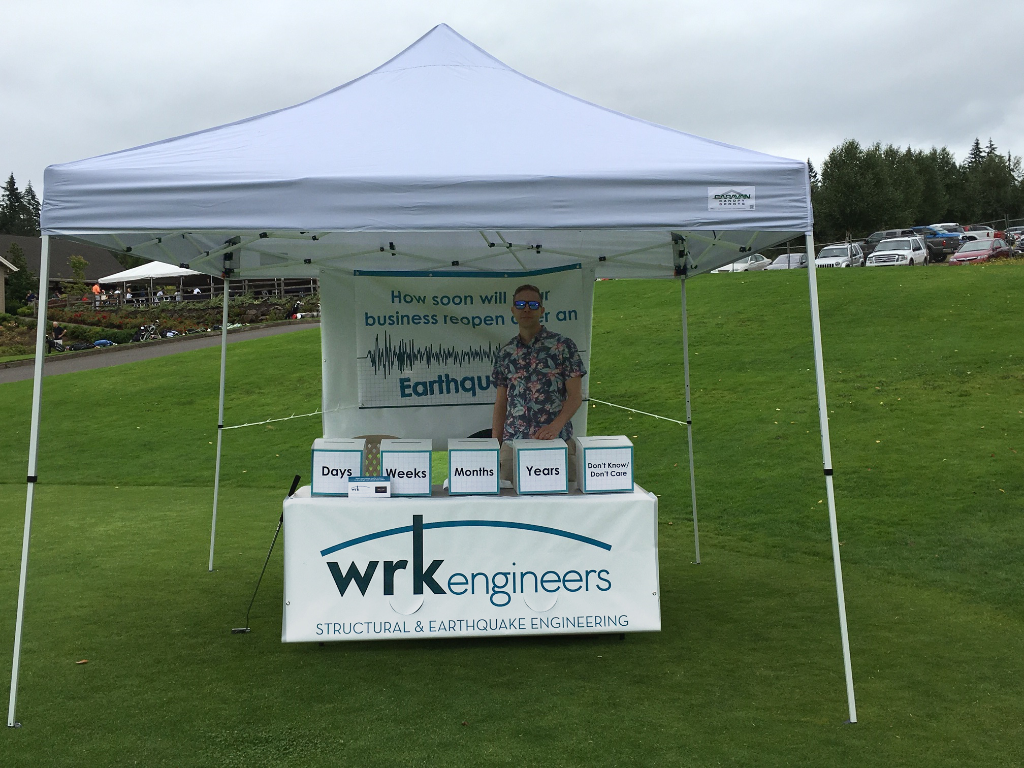 Devin Gustafson standing at the WRK tent at the CREDC Golf Classic