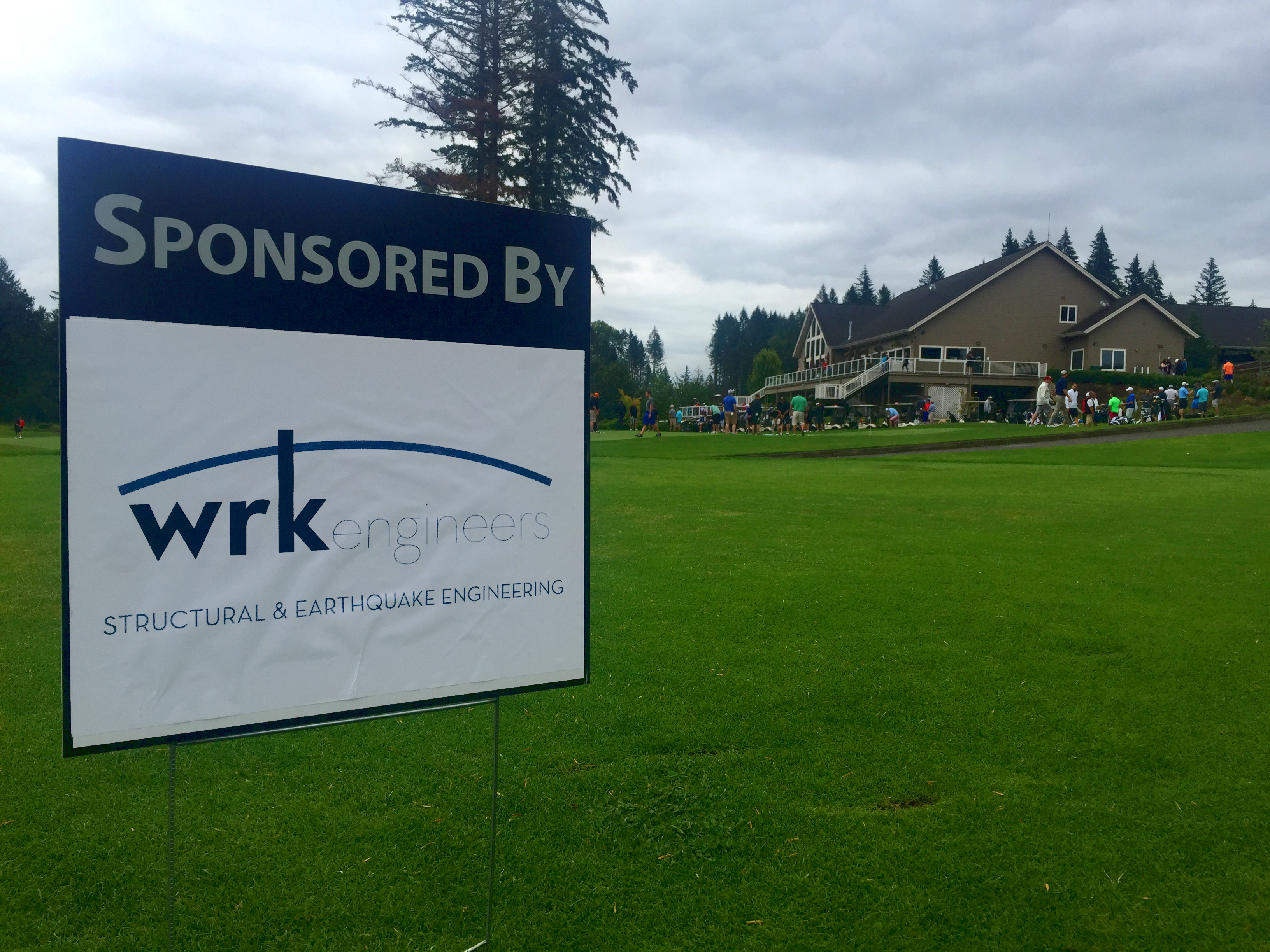 "Sponsored by WRK Engineers" sign on golf tee box at Camas Meadows